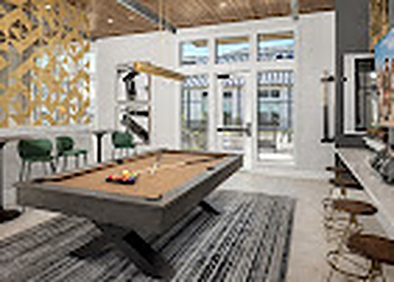 Game room with a pool table and gold geometric screen, Alexan Lake Olympia