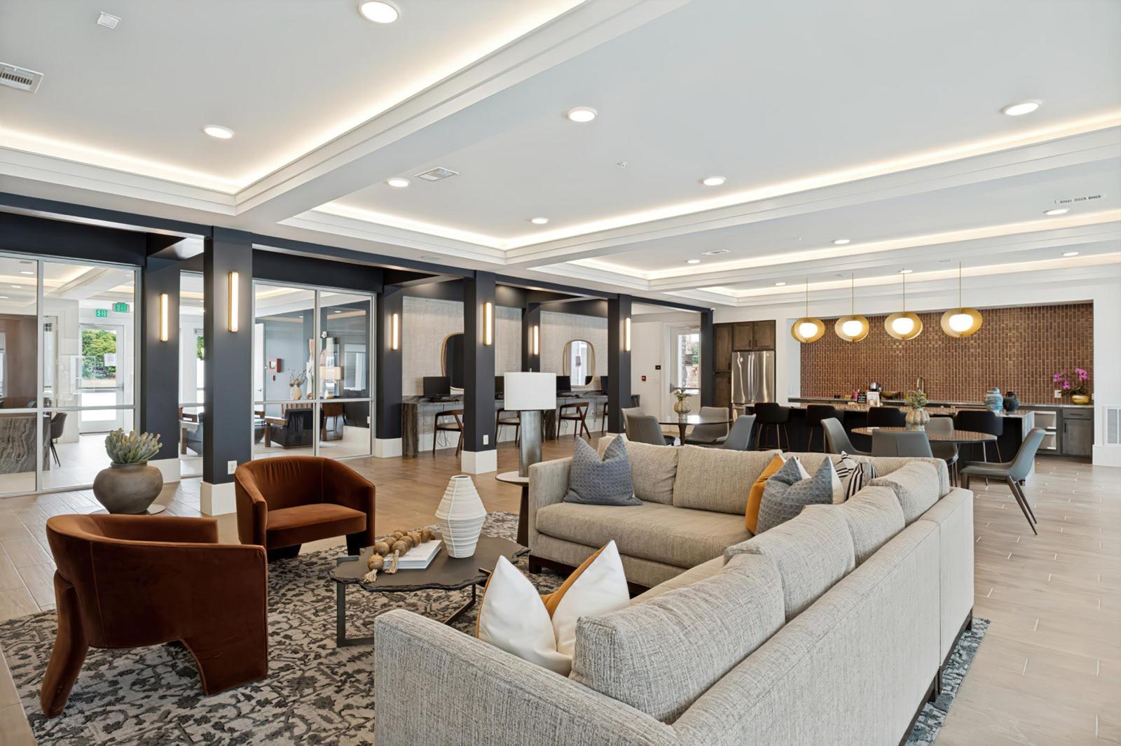 Open clubhouse lounge with a sectional sofa and rust velvet chairs, Allegra at Shreveport