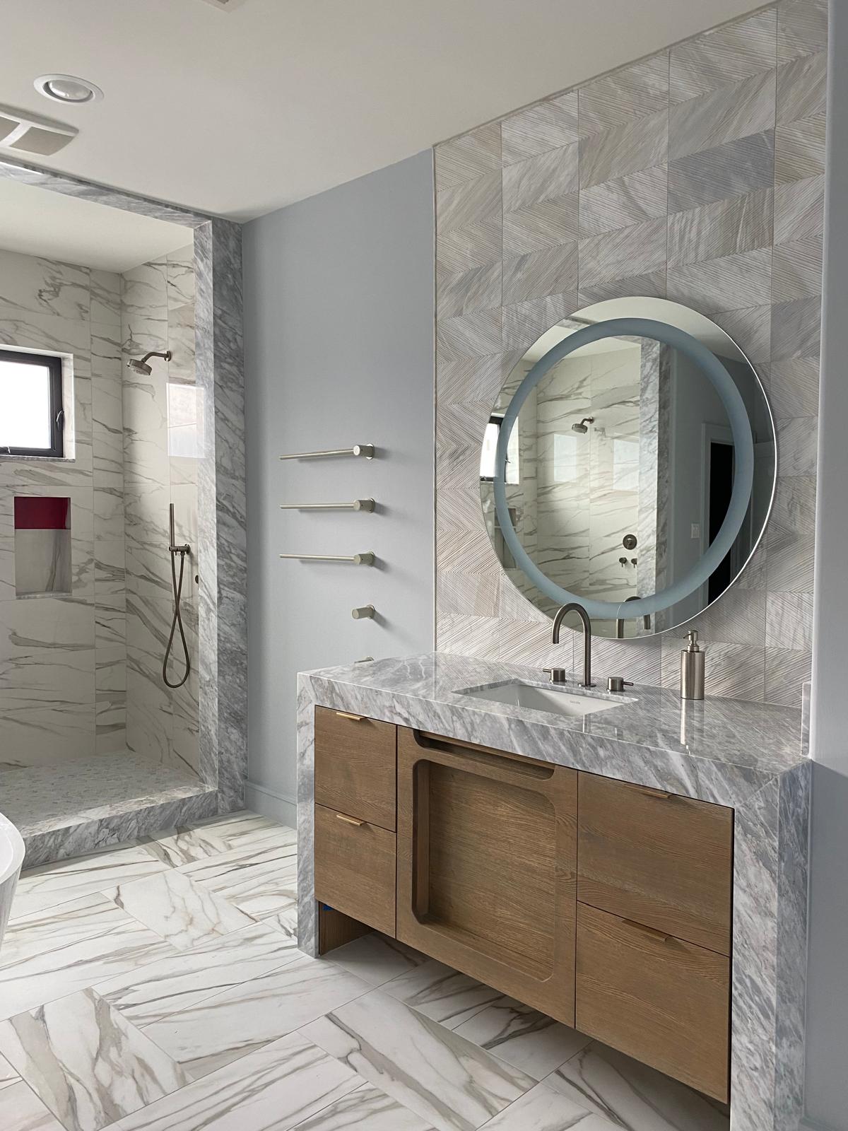 Second view of the white oak vanity, round mirror and marble shower, Montrose